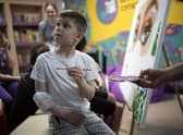 An injured boy from the southern Ukrainian city of Mariupol takes part in an arts therapy session in Kyiv last year. Picture: Getty Images