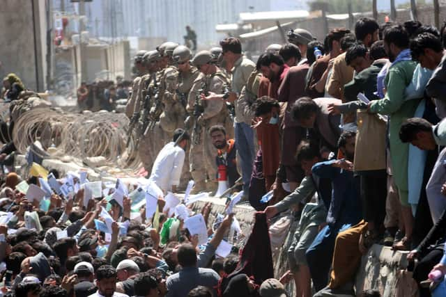 Afghans try to reach foreign forces to show their credentials at Kabul Airport (Picture: Akhter Gulfam/EPA-EFE/Shutterstock)