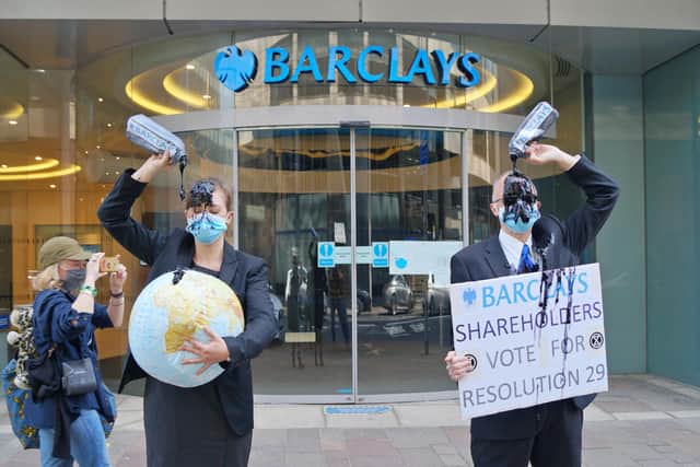 The pair made the protest outside a Glasgow branch of Barclays.