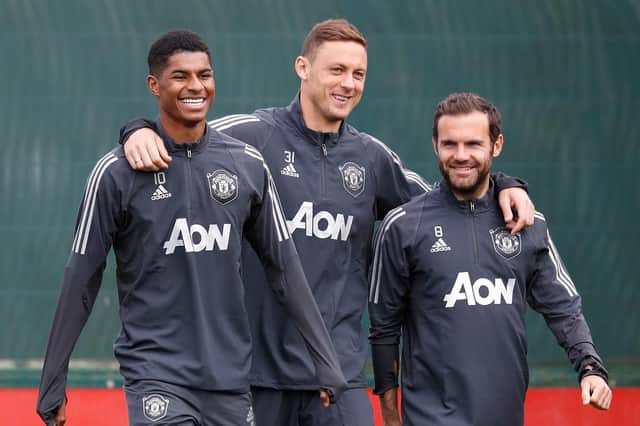 Manchester United's Marcus Rashford, seen on left with teammates Nemanja Matic, centre, and Juan Mata, persuaded Boris Johnson to allow 1.3 million children to claim free school meals over the summer holidays (Picture: Martin Rickett/PA Wire)