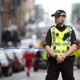 A police officer staffs a cordon as emergency services attend the scene of a fatal stabbing incident at the Park Inn Hotel in central Glasgow on June 26, 2020. - Scottish police on Friday said armed officers shot dead a man after a suspected stabbing in Glasgow left six others injured, including one of their colleagues.  The incident happened in and around a Park Inn hotel on West George Street, in the heart of the city. Several roads were closed and the surrounding area was cordoned off. (Photo by Robert Perry / AFP) (Photo by ROBERT PERRY/AFP via Getty Images)