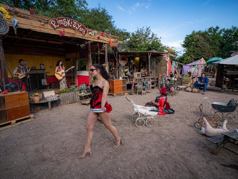 A folk singer performs onstage at Rimski's Yard at the Glastonbury Festival