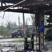 A Russian military truck painted with the letter Z is seen behind a destroyed petrol station in Ukraine's port city of Mariupol on May 18, 2022, amid the ongoing Russian military action in Ukraine. (Photo by Olga MALTSEVA / AFP) (Photo by OLGA MALTSEVA/AFP via Getty Images)