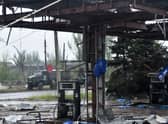 A Russian military truck painted with the letter Z is seen behind a destroyed petrol station in Ukraine's port city of Mariupol on May 18, 2022, amid the ongoing Russian military action in Ukraine. (Photo by Olga MALTSEVA / AFP) (Photo by OLGA MALTSEVA/AFP via Getty Images)