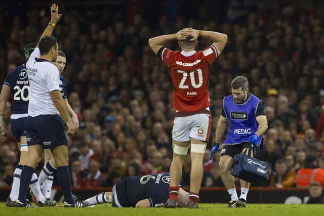 Scotland's Luke Crosbie lies on the pitch injured the victory over Wales.