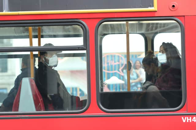 A man and woman wearing protective face masks on a bus. Picture: Yui Mok/PA Wire