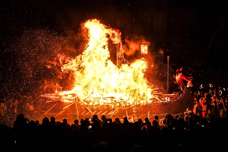 Up Helly Aa celebrates the influence of the Scandinavian Vikings in the Shetland Islands and culminates with up to 1,000 'guizers'throwing flaming torches into their Viking longboat and setting it alight later in the evening. (Photo by Andy Buchanan / AFP)