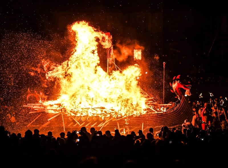 Up Helly Aa celebrates the influence of the Scandinavian Vikings in the Shetland Islands and culminates with up to 1,000 'guizers'throwing flaming torches into their Viking longboat and setting it alight later in the evening. (Photo by Andy Buchanan / AFP)