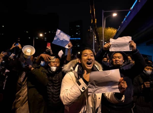 A protester shouts slogans against China's strict zero COVID measures on November 28, 2022 in Beijing, China. Protesters took to the streets in multiple Chinese cities after a deadly apartment fire in Xinjiang province sparked a national outcry as many blamed Covid restrictions for the deaths.