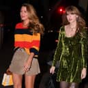 Singer Taylor Swift, pictured with actress Blake Lively, wears a dress designed by Perth-based firm Little Lies to a party at a Brooklyn pizza restaurant on Wednesday. The dress has now sold out. Picture: Robert Kamau/GC Images