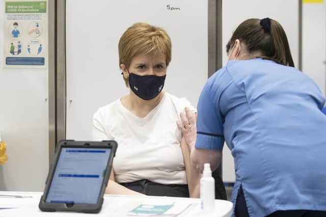Nicola Sturgeon receives the first shot of the Astra Zeneca vaccine, administered by staff nurse Elaine Anderson, at the NHS Louisa Jordan vaccine centre in the SSE Hydro.