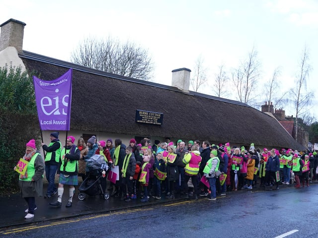 Striking teachers from the EIS gather on the anniversary of Robert Burns' birth in 1759 outside the cottage in Alloway, Ayrshire