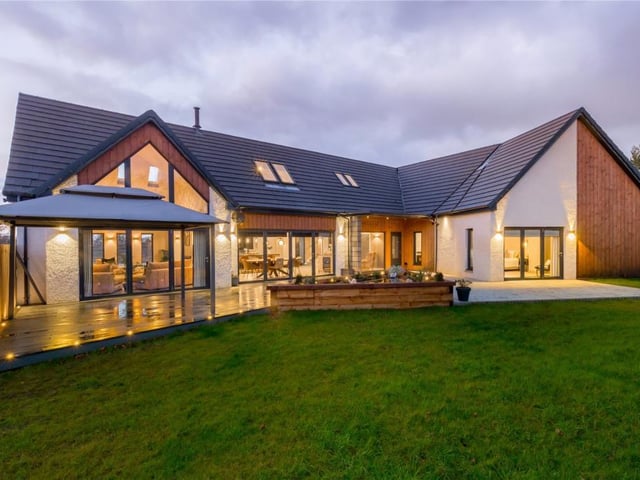 Rear of property with decking and patio areas.
