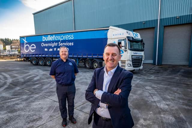 David McCutcheon, joint CEO, and John McKail, MD, Bullet Express outside new logistics storage facility with Andrea Gardner at the wheel of the truck. Picture: Peter Devlin