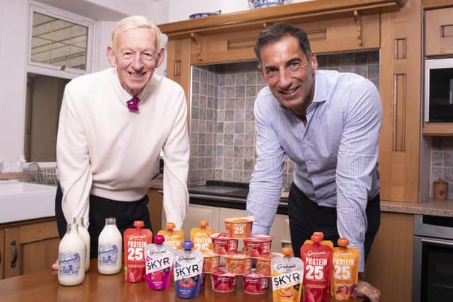 Dr Robert Graham with his son Robert Graham, managing director, and some of Graham's The Family Dairy's products. Picture: Gibson Digital / Graham's The Family Dairy