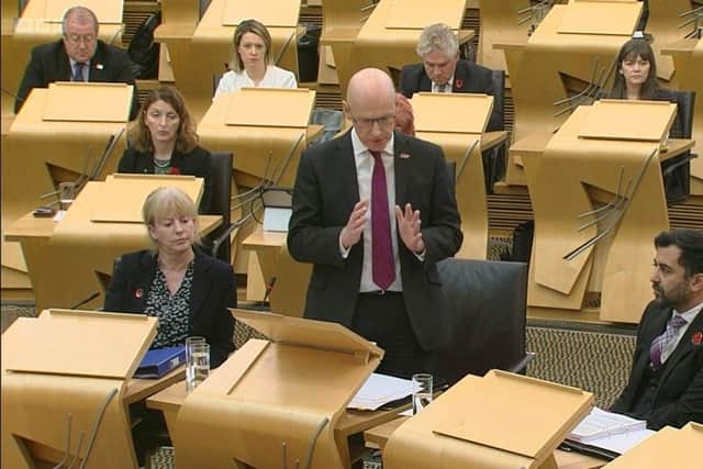 John Swinney, standing alongside health secretary Humza Yousaf, speaks at First Minister's Questions. Picture: Scottish Parliament TV
