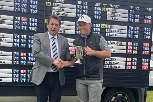 Grangemouth-attached Graeme Robertson is presented with the Northern Open trophy by PGA in Scotland manager David Longmuir after his play-off win at Cruden Bay. Picture: PGA in Scotland