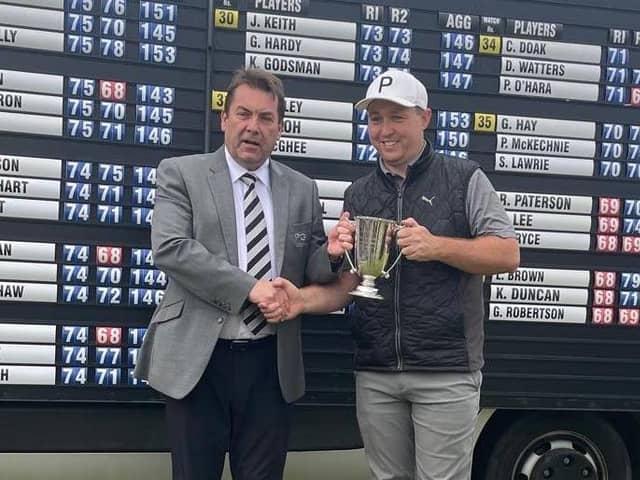 Grangemouth-attached Graeme Robertson is presented with the Northern Open trophy by PGA in Scotland manager David Longmuir after his play-off win at Cruden Bay. Picture: PGA in Scotland