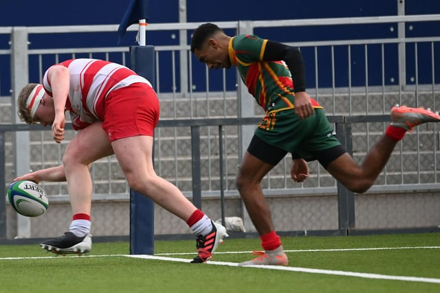 Loretto's Finn Duraj scores his try