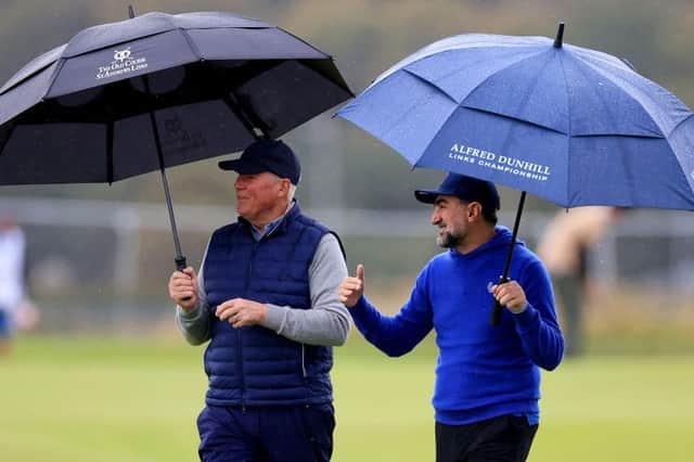Martin Slumbers, chief executive of The R&A and LIV Golf chairman Yasir Al-Rumayyan chat during the opening round of the Alfred Dunhill Links Championship at St Andrews. Picture: Stephen Pond/Getty Images.