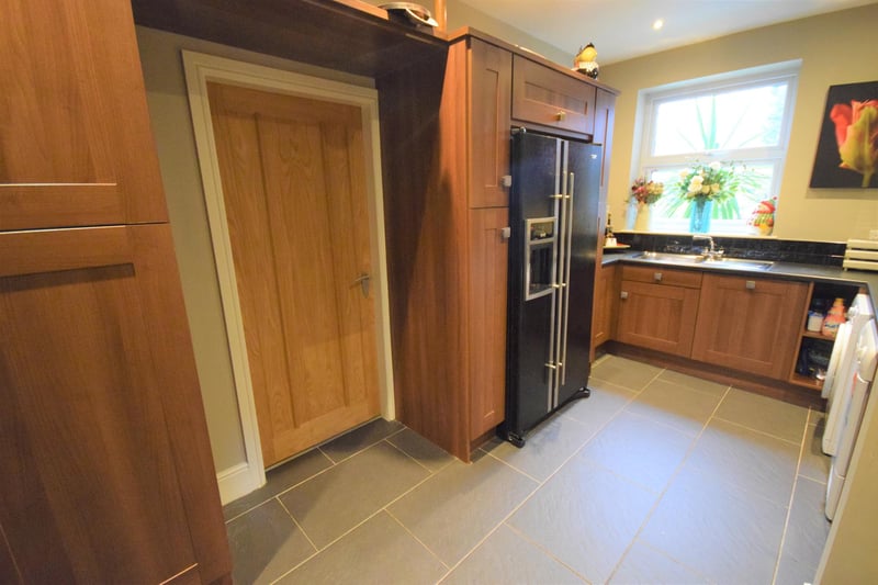 Conveniently next to the kitchen, the utility room has a stainless steel oven, dishwasher, plumbing for washing machine and for a tumble drier, numerous cabinet units and space for an American-style fridge-freezer.