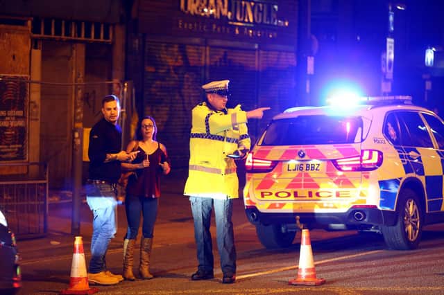 A police officer directs people away from a cordoned off street near the Manchester Arena on May 22, 2017, after initial reports of an explosion (Picture: Dave Thompson/Getty Images)
