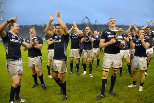 Captain Al Kellock holds the silverware as Scotland celebrate their Test series triumph over Argentina in 2010 after winning the second match in Mar del Plata. Picture: STR/AFP via Getty Images