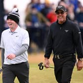 Fellow left-handers Bob MacIntyre and Phil Mickelson enjoy walking down the 18th hole together in the final round of the 152nd Open at Royal Troon. Picture: Ross Kinnaird/Getty Images.
