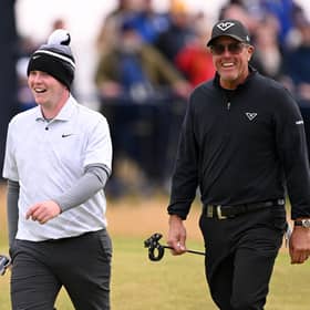 Fellow left-handers Bob MacIntyre and Phil Mickelson enjoy walking down the 18th hole together in the final round of the 152nd Open at Royal Troon. Picture: Ross Kinnaird/Getty Images.