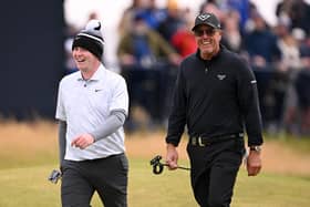 Fellow left-handers Bob MacIntyre and Phil Mickelson enjoy walking down the 18th hole together in the final round of the 152nd Open at Royal Troon. Picture: Ross Kinnaird/Getty Images.
