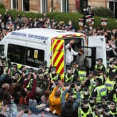 Lakhvir Singh and Sumit Sehdev are released from the back of a Home Office immigration enforcement van in a Glasgow street after crowds of people prevented it from leaving (Picture: Andrew Milligan/PA)