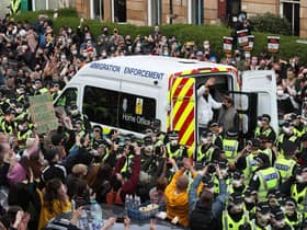 Lakhvir Singh and Sumit Sehdev are released from the back of a Home Office immigration enforcement van in a Glasgow street after crowds of people prevented it from leaving (Picture: Andrew Milligan/PA)