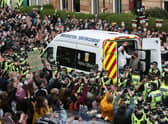 Lakhvir Singh and Sumit Sehdev are released from the back of a Home Office immigration enforcement van in a Glasgow street after crowds of people prevented it from leaving (Picture: Andrew Milligan/PA)