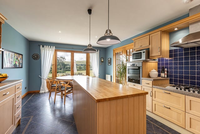 Interior: The house is entered via a rear veranda and all rooms are connected by a central hallway. The lounge offers bucolic views from its large windows and an open-plan kitchen-diner has doors opening to the garden. Two bedrooms are on the ground level and two are upstairs.