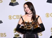 US singer Olivia Rodrigo poses with her various awards during the 64th Annual Grammy Awards. Photo: Patrick T. FALLON / AFP via Getty Images.