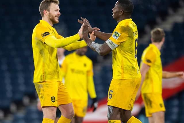 Livingston's Nicky Devlin (left) and Marvin Bartley at full time during the Betfred Cup semi-final between Livingston and St Mirren at Hampden. (Photo by Ross Parker / SNS Group)