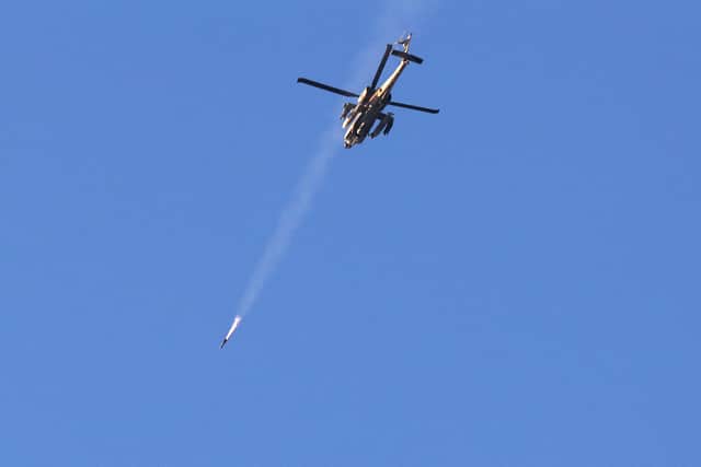 An Israeli air force attack helicopter fires a missile while flying over the border with the Gaza Strip near southern Israel. Picture: Jack Guez/AFP/Getty