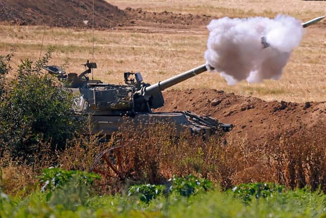 Israeli soldiers fire shells towards the Gaza Strip from a position along the border (Picture: Jack Guez/AFP via Getty Images)