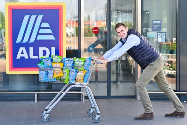 James Taylor of Taylors Snacks outside an Aldi store with his company's crisps. Picture: Julie Howden