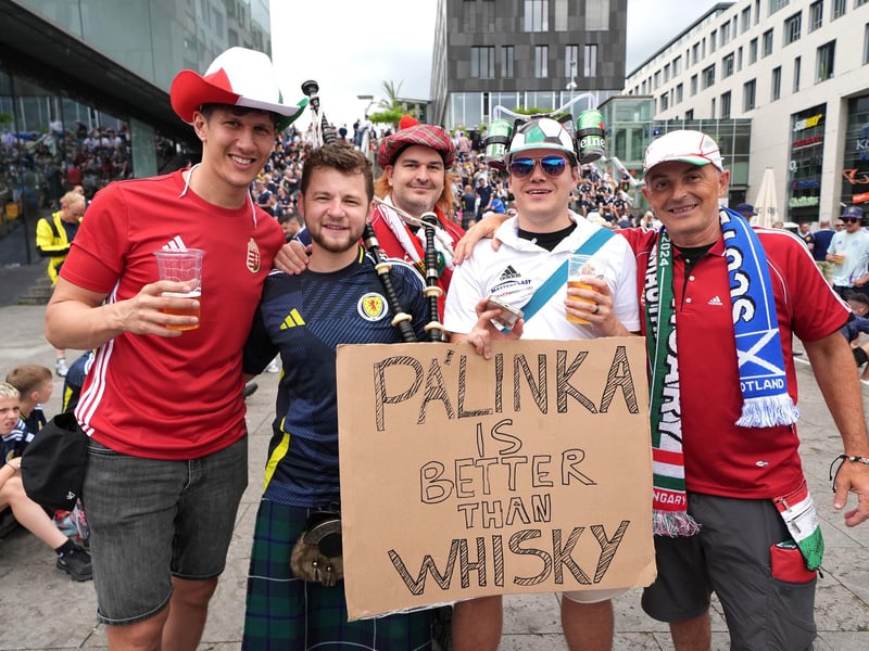 Hungary fans pose with a Scotland fan playing bagpipes in Stuttgart ahead of their Euro 2024 group A game against Hungary this evening.