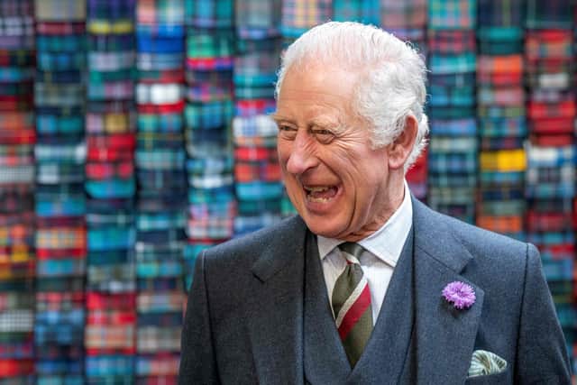 King Charles III laughs during a visit to the Lochcarron of Scotland weaving mill in Selkirk. Picture: Jane Barlow/AFP via Getty Images