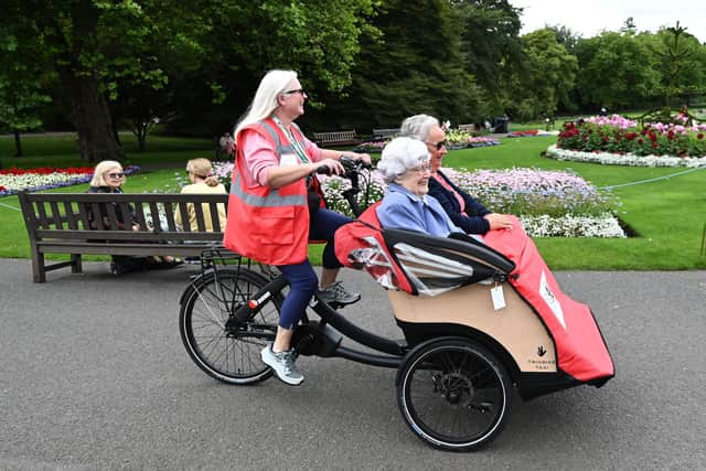 The electric trishaws are ridden at walking space so passengers can chat with passers-by. Picture: John Devlin