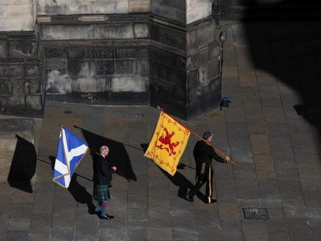 The Lion Rampant and Saltire flags are carried into St Giles' Cathedral, Edinburgh, following a Service of Prayer and Reflection for her life.