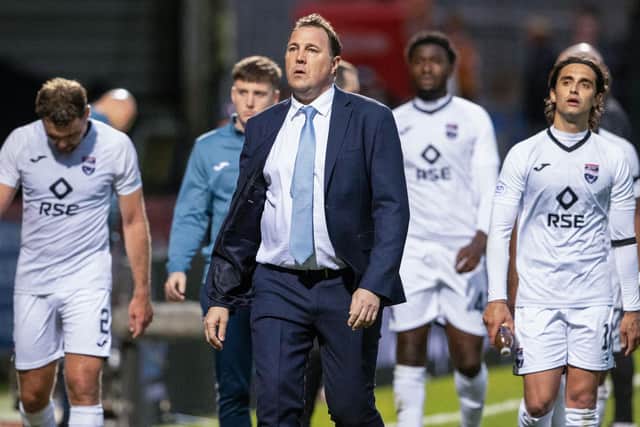 A dejected Ross County manager Malky Mackay leads his team off the Firhill pitch - they require a strong victory to preserve their Premiership status.