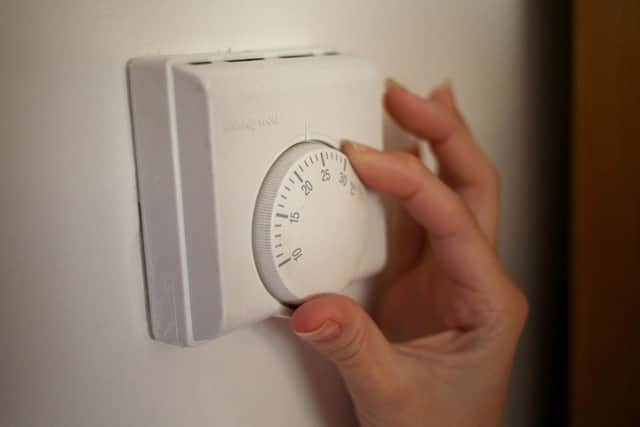 A person using a central heating thermostat. Picture: Steve Parsons/PA Wire
