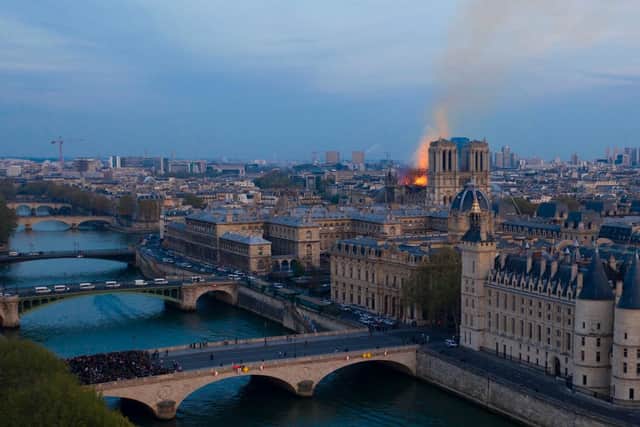 Images posted on social media showed flames and huge clouds of smoke billowing above the roof of the Gothic cathedral, the most visited historic monument in Europe.