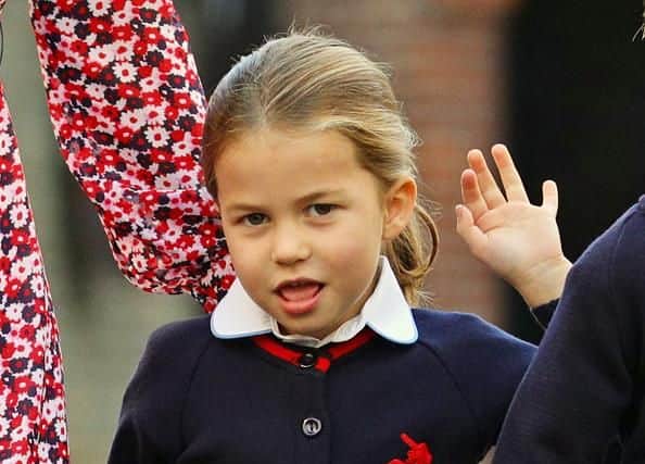 Princess Charlotte smiled and waved to the cameras as she arrived for her first day.