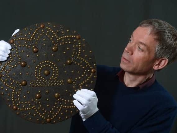 Hugh Morrison examines an 18th century shield used by Highland clansmen.