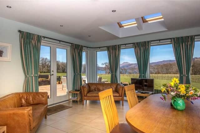 Part of the extension is this garden room with its triple aspect windows providing panoramic views across the loch and over to Ben Lomond beyond.