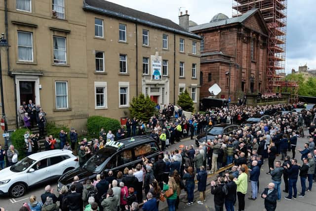 Celtic fans line the street as Billy McNeill's coffin passes